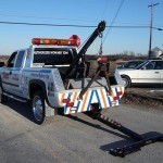 Hidden wheel lift deployed from a tow truck