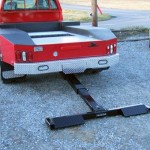 Pickup truck with a lift and tow hidden wheel lift attached and deployed.
