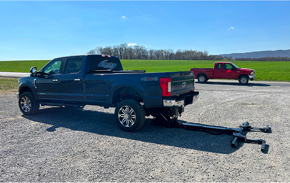 blue-pickup-truck-tow-dolly-attachment-rural-setting